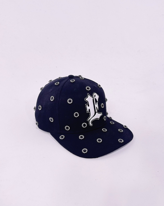 Black cap with decorative gemstone on a white background