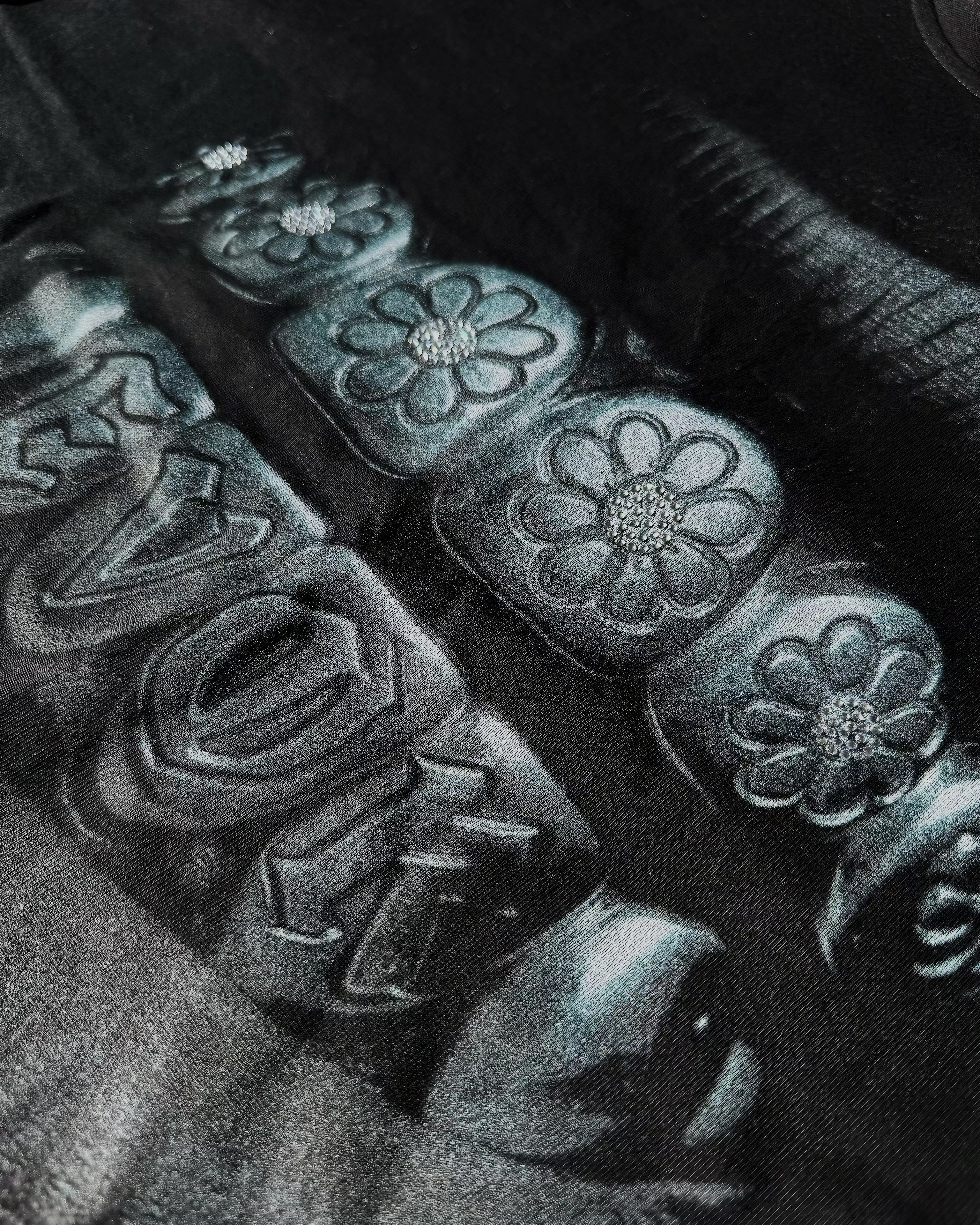 Close-up of decorative car seat covers with 'EVOK' branding and grillz image.