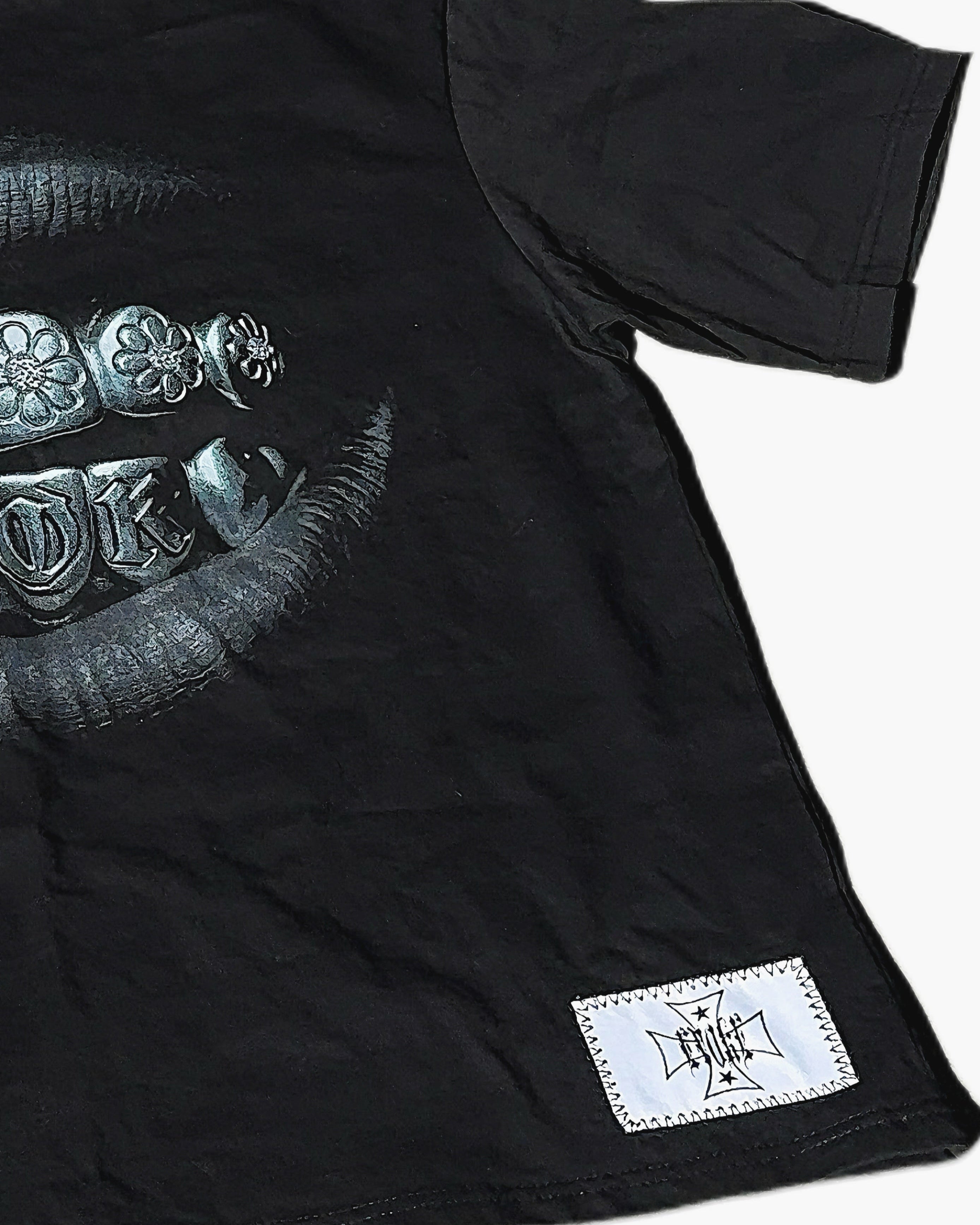 Black t-shirt with a graphic design and a label on a white background