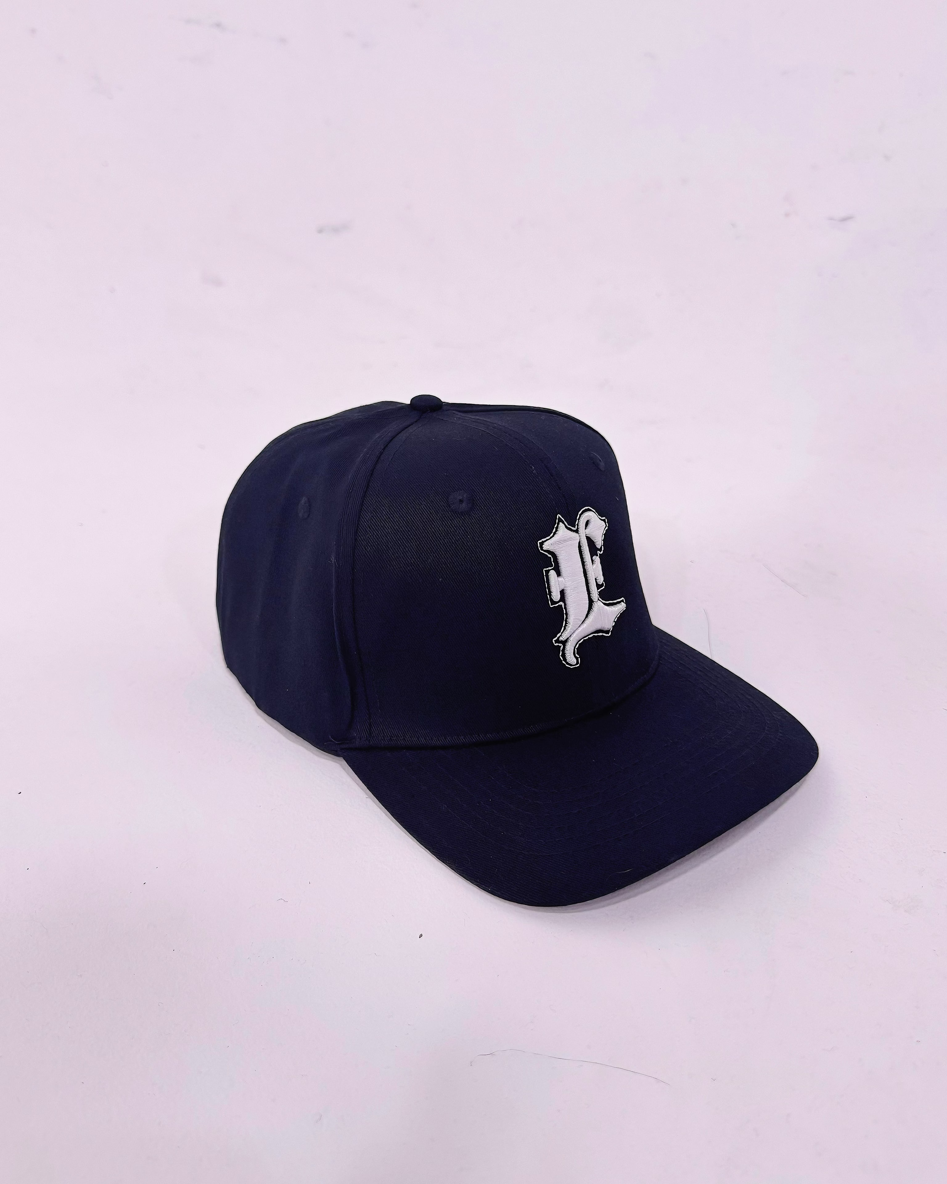 Black cap with a white logo on a light gray background