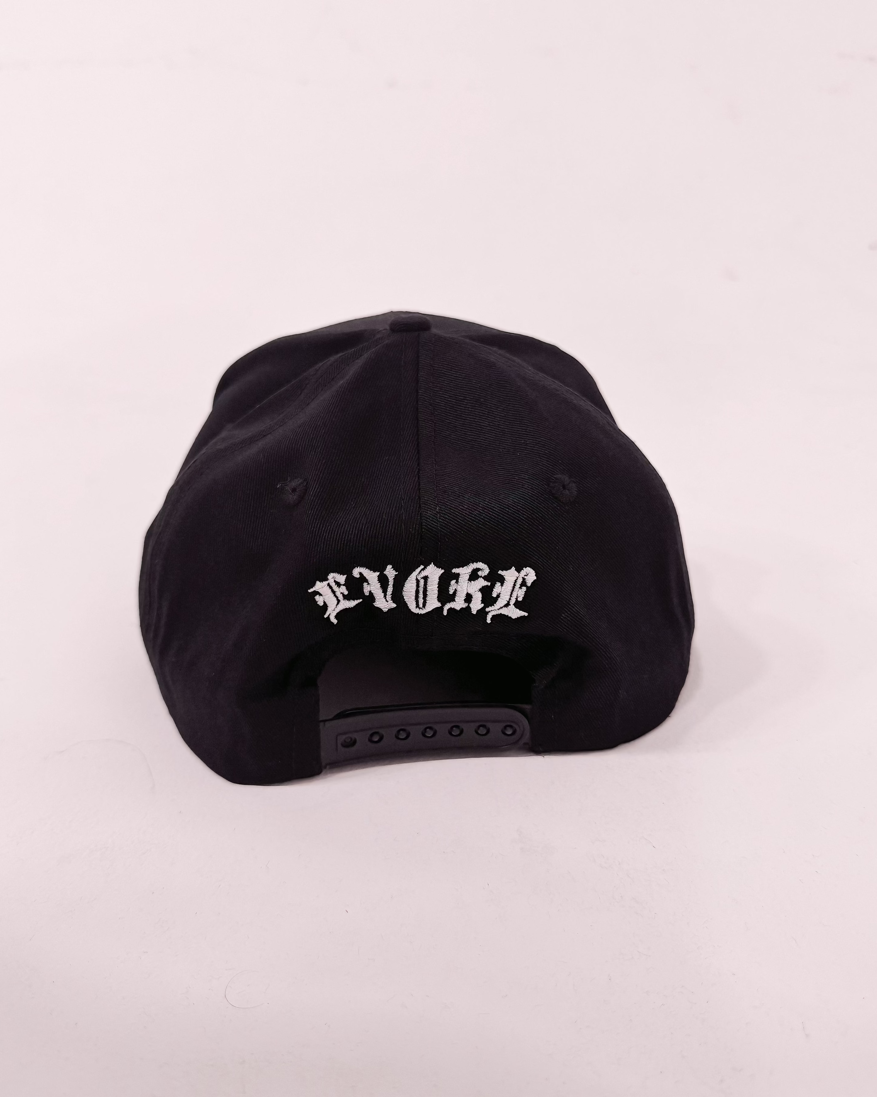 Black cap with white text on a light gray background