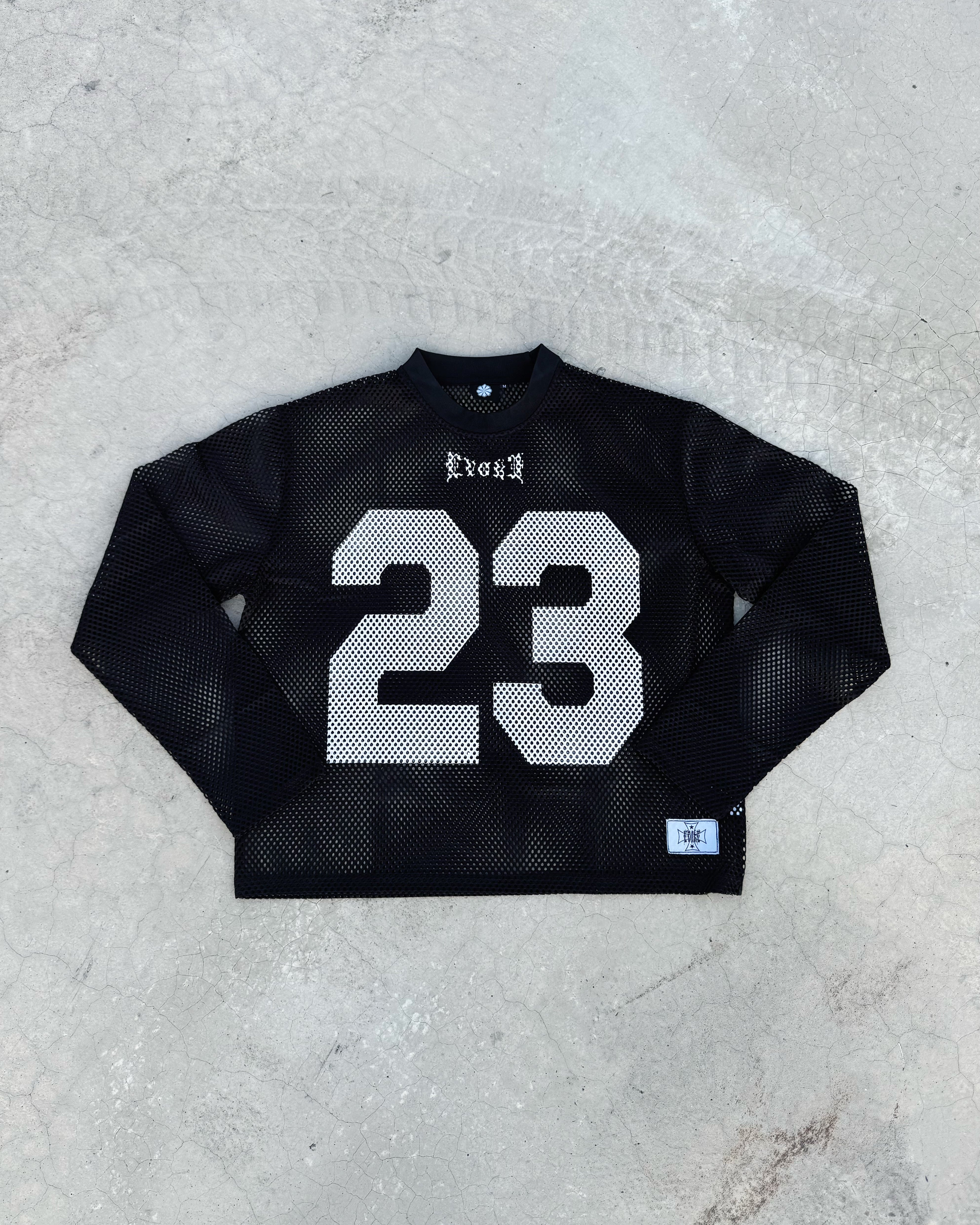 Black long-sleeve shirt with number 23 on a gray surface